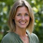 Portrait of Elara Thorne, a kind-faced woman with warm eyes, standing in a natural setting